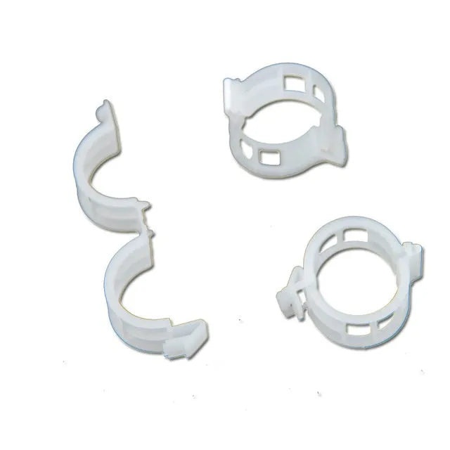 Set of 50 green plastic plant grafting clips for securing tomato vines and garden plants.