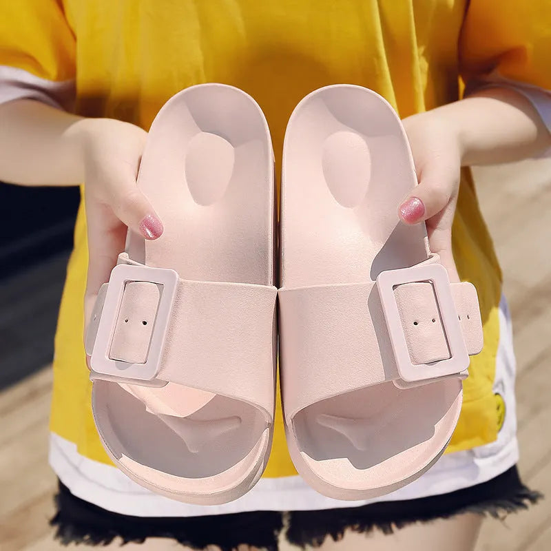 Women's grey blue buckle closure slipper sandals with soft EVA sole on a plain background.