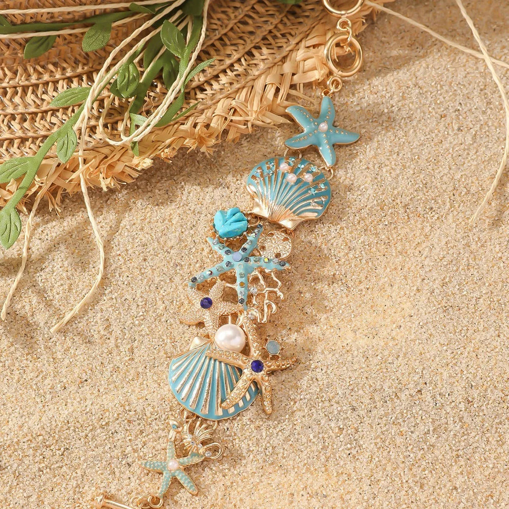 Close-up of a women's alloy starfish rhinestone bracelet in turquoise colour.