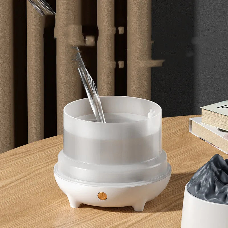 White volcano-shaped ultrasonic humidifier and aromatherapy diffuser with USB cable.