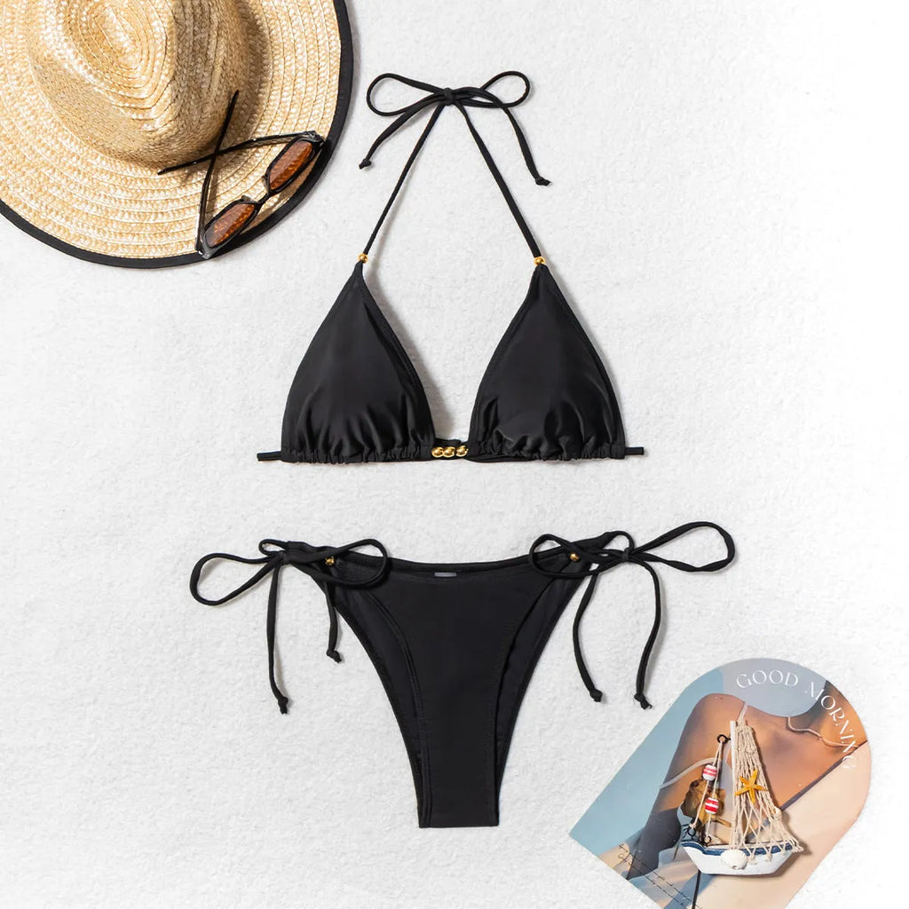 Black women's two-piece bikini swimsuit with metal bead decoration and high-cut legs.