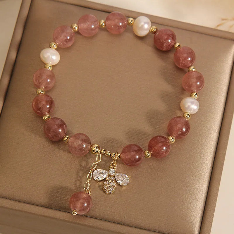 Women's bracelet with freshwater pearls, strawberry quartz beads, zircon accents, and an alloy clasp.