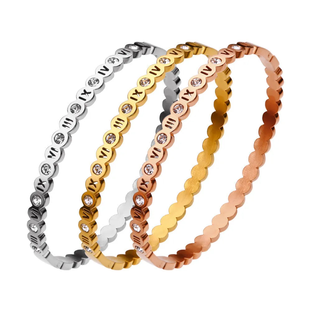 Adjustable titanium steel fashion bracelet with number charms in a choice of gold, rose gold, or steel colour.