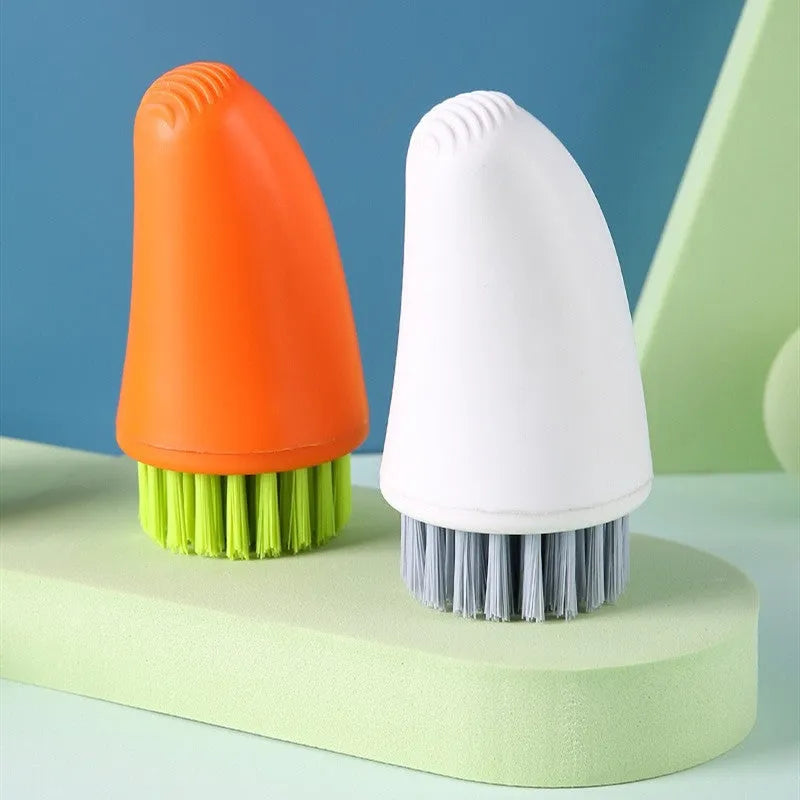 White and orange carrot-shaped nylon kitchen cleaning brush with dense bristles.