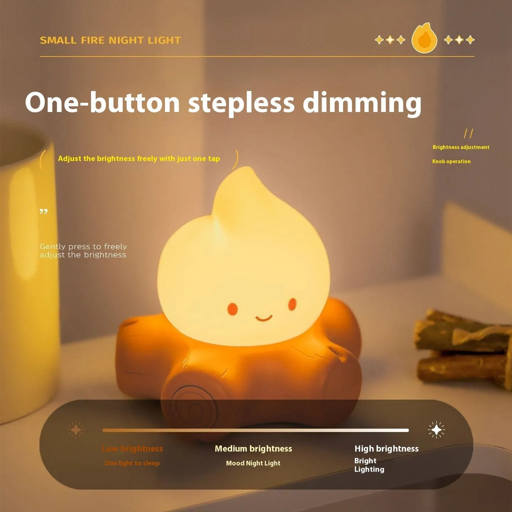 Silicone small fire pile shaped cartoon night light with yellow glow on a surface.