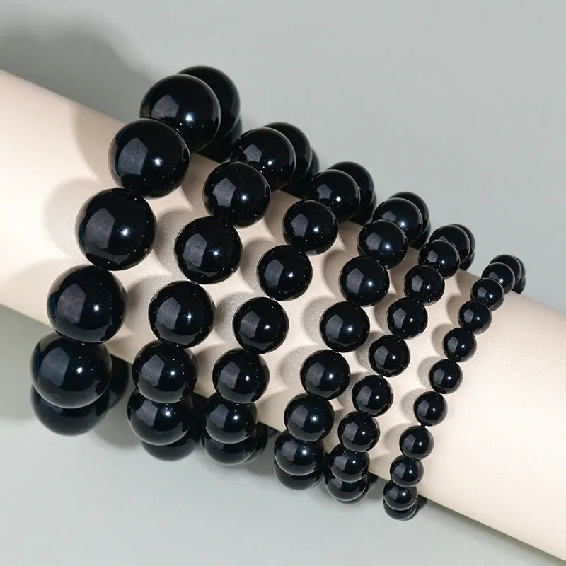 Hand-woven obsidian couple bracelets showing six crystal colour variations with round beads in ethnic style design