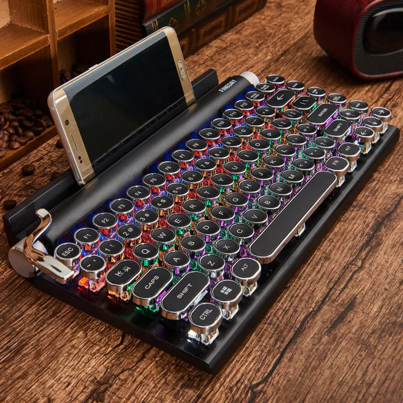 Black retro mechanical keyboard with 83 keys, metal body, and seven-colour backlight on a desk