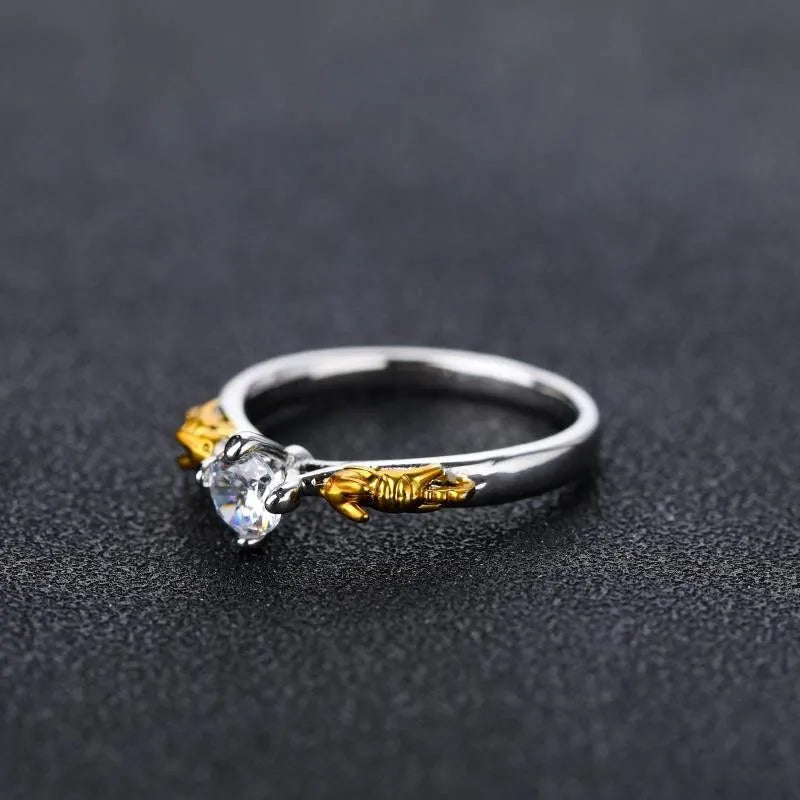 Black gold copper crown crystal ring for cosplay on a grey background.