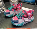Pair of thick-soled leather sports casual shoes with wedge heels and front lace-up fastening.
