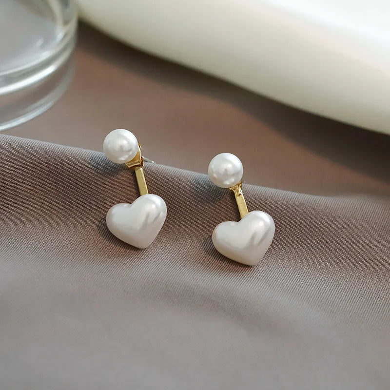 Korean style heart-shaped women's stud earrings with pearl design and alloy construction