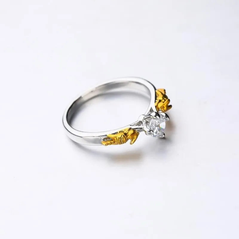 Black gold copper crown crystal ring for cosplay on a grey background.