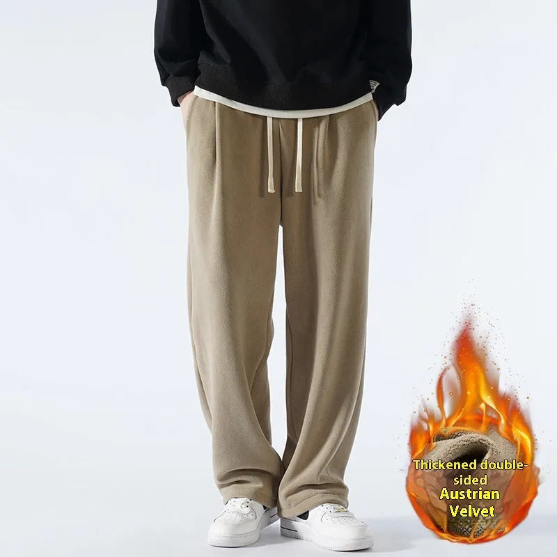 Men's apricot fleece-lined loose-fit sports casual trousers with elastic waist on a hanger.