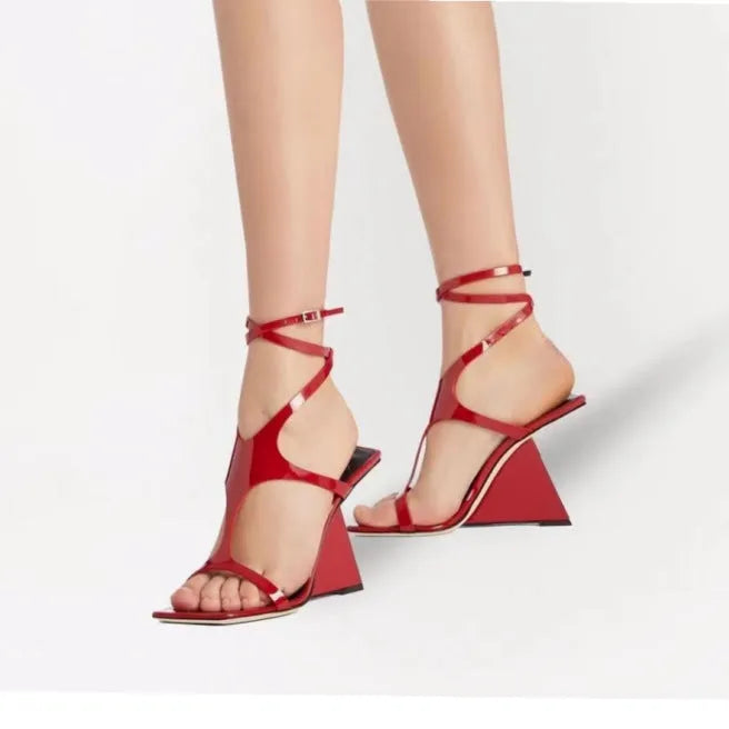 Women's black high heel sandals with a square toe and button strap fastening.