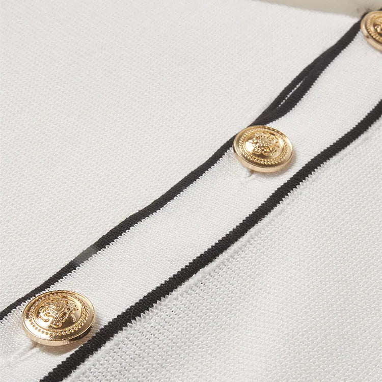 White short-sleeve cardigan with dark contrast lapels, laid flat.