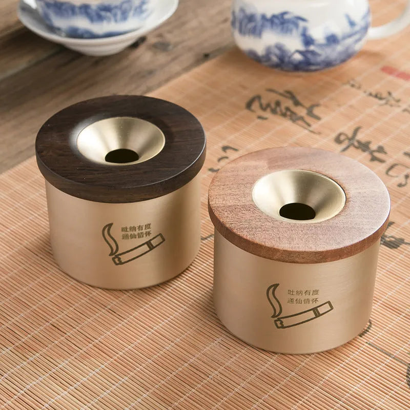 Brass ashtray with wooden lid showing centre hole design and copper construction