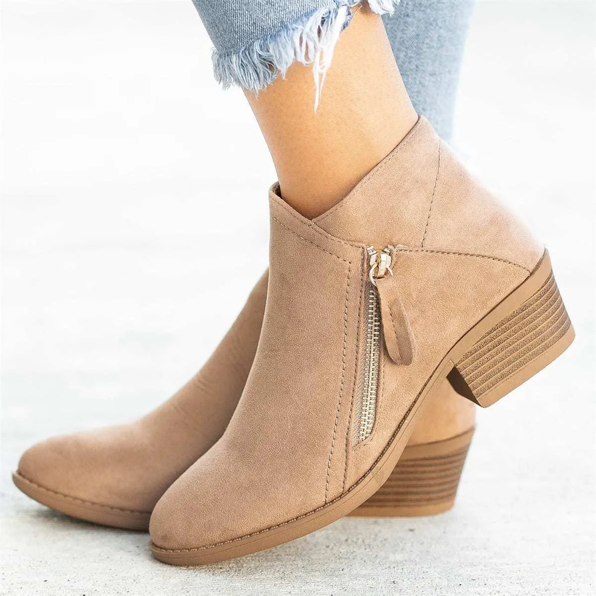 Women's blue suede ankle boots with side zip and chunky heel on a white background