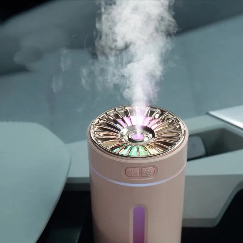 Black portable car humidifier with colourful LED lights on car cup holder showing mist output