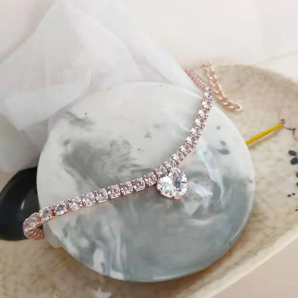 Gold rhinestone heart-shaped collar for dogs or cats on a white background.