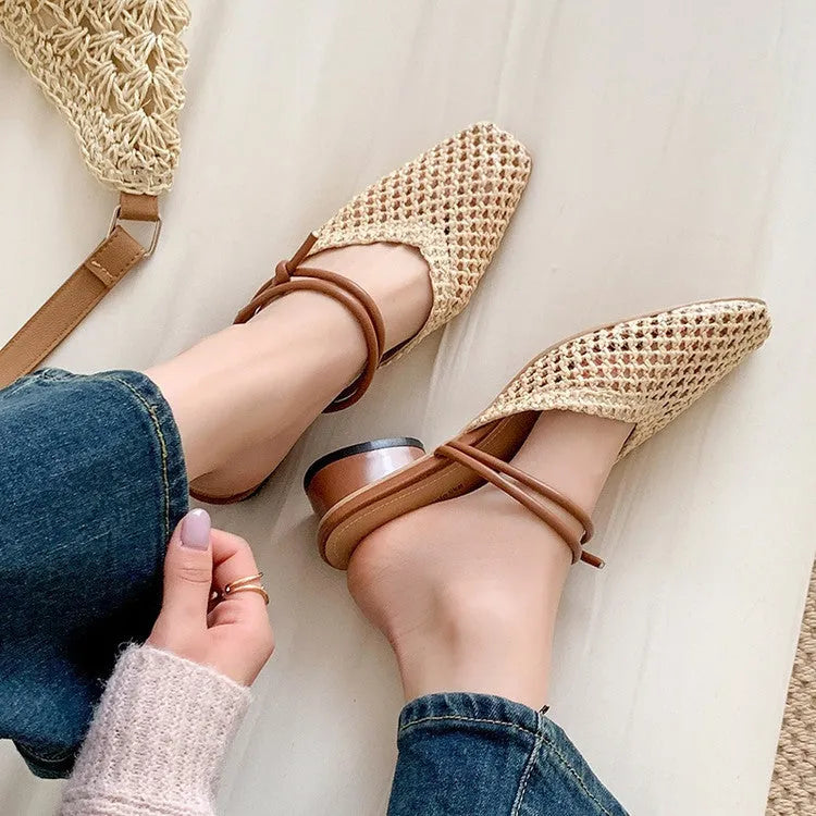 Women's black square toe slippers with chunky heel and breathable hollow-out design on a wooden floor