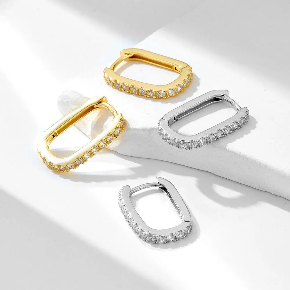 Sterling silver clip-on earrings with oval zircon stone in geometric design