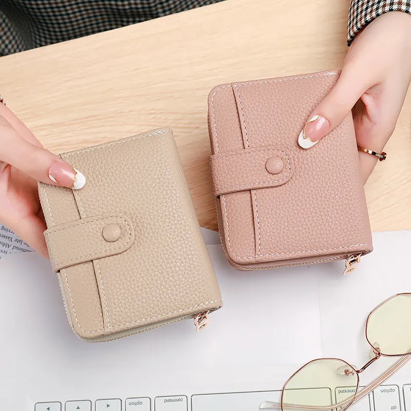 Ladies' short bifold wallet with embossed lychee pattern in PU leather, shown closed.