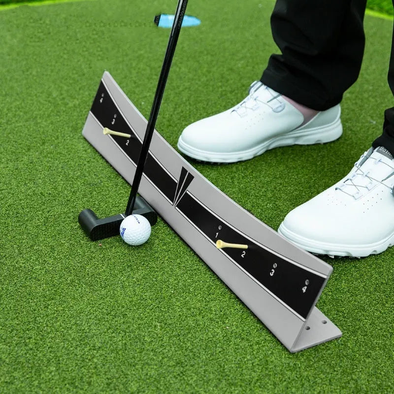 Golf putter trajectory balance simulator with adjustable push rod on a practice green.