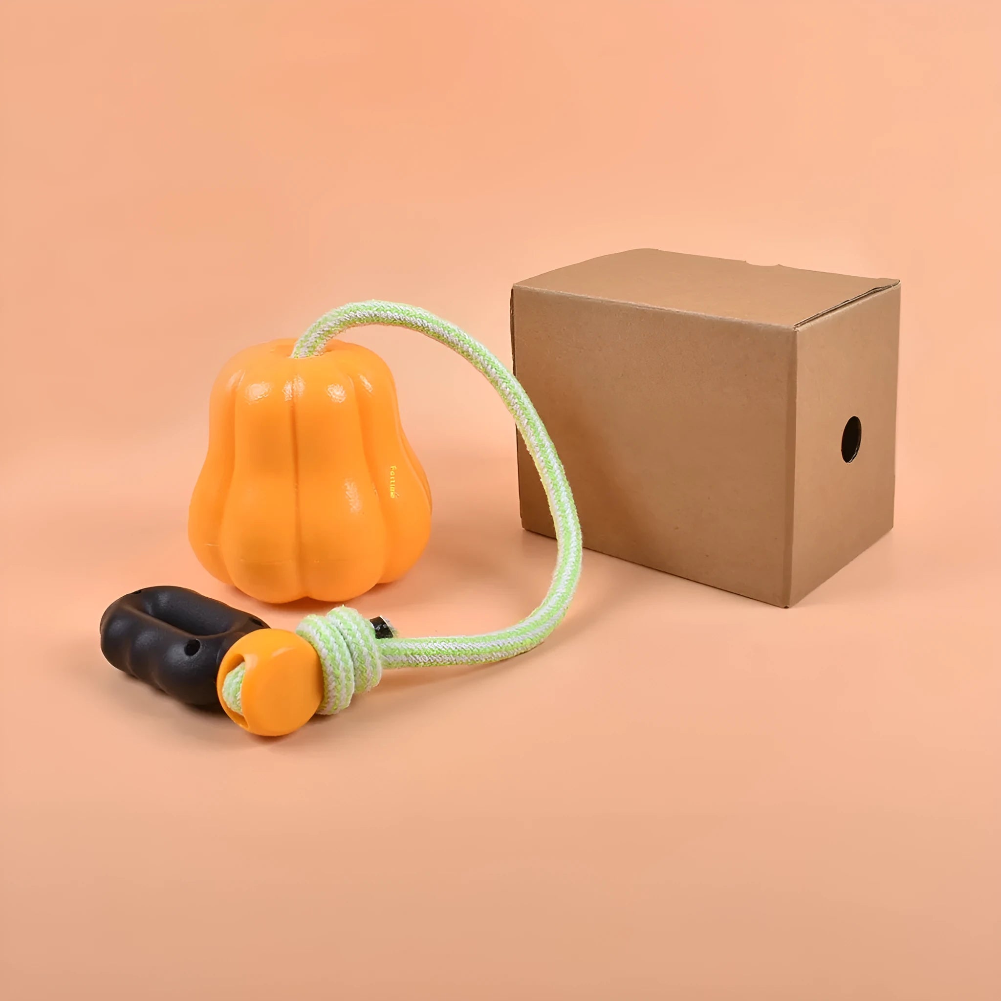 Pumpkin coloured plastic dog chew toy with a blue rope handle for tug and fetch.