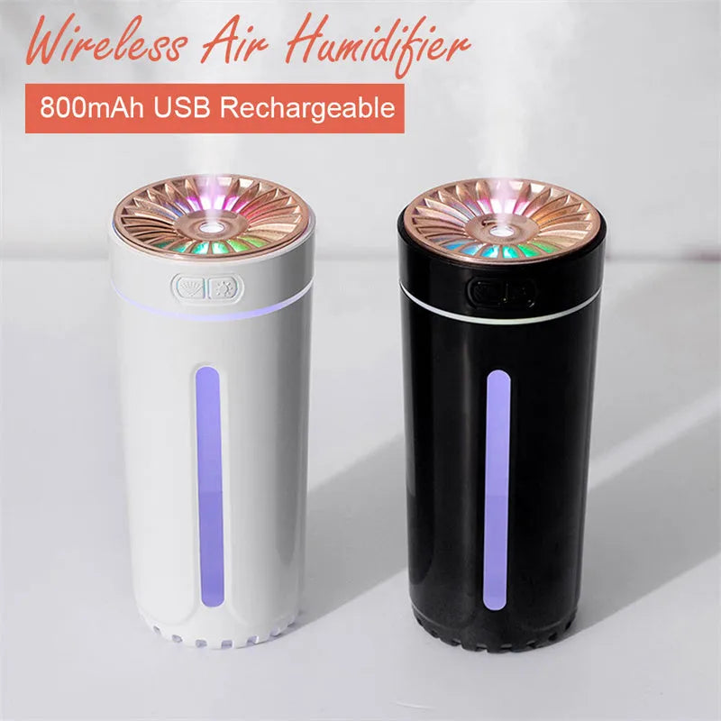 Black portable car humidifier with colourful LED lights on car cup holder showing mist output