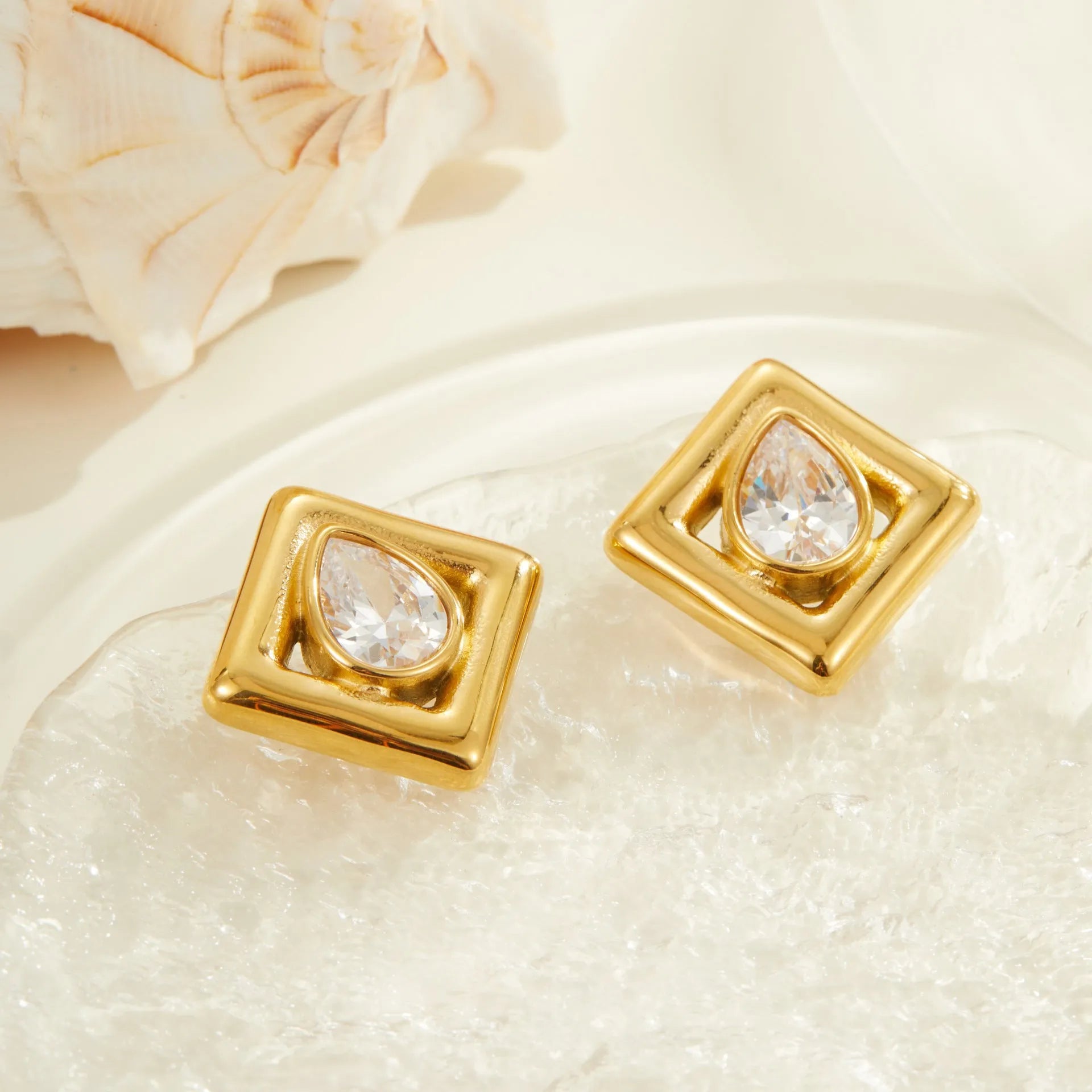 Gold electroplated stud earrings with geometric water drop zircon stone patterns