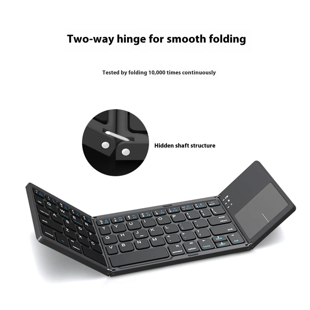 Black mini tri-fold Bluetooth keyboard unfolded next to a tablet, showing its compact size.