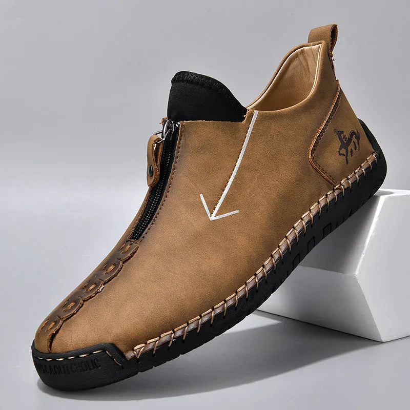 Men's black martin boot with front zipper and round toe on a rubber sole.