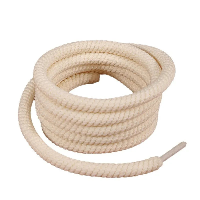 Round woven shoelaces for Bread Shoes in white, beige and black colours on a white background.