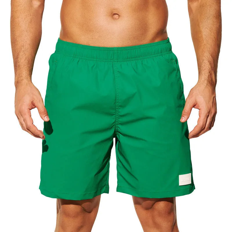 Men's solid colour quick-drying nylon beach shorts in a straight-leg style on a mannequin.