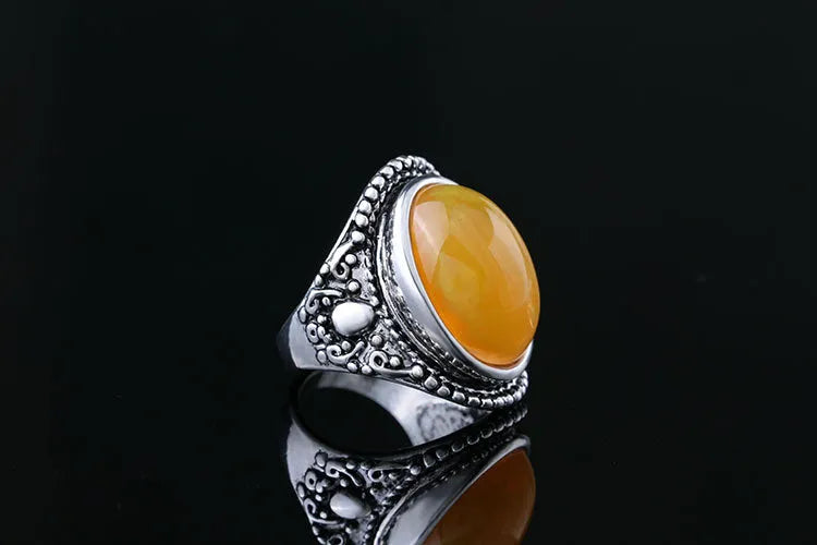 Fluorescent beeswax centre geometric ring in antique silver on a hand.