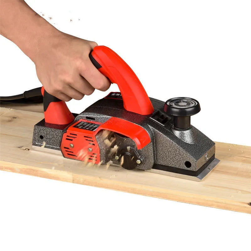 Red desktop electric wood planer with aluminium housing and 82mm planing width