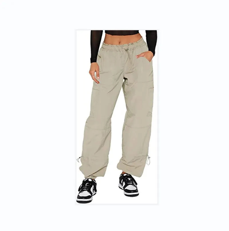 Man wearing beige multi-pocket cargo trousers with a loose straight-leg fit, showcasing the utility pockets.