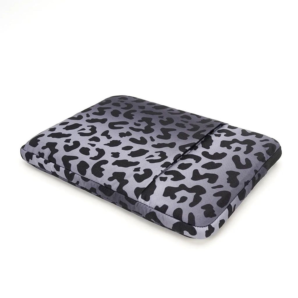 Leopard print laptop sleeve for 13-inch to 16-inch devices with waterproof polyester and anti-shock lining.