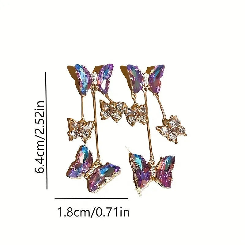 Blue purple butterfly earrings with crystal flowers and tassel details on silver needle posts
