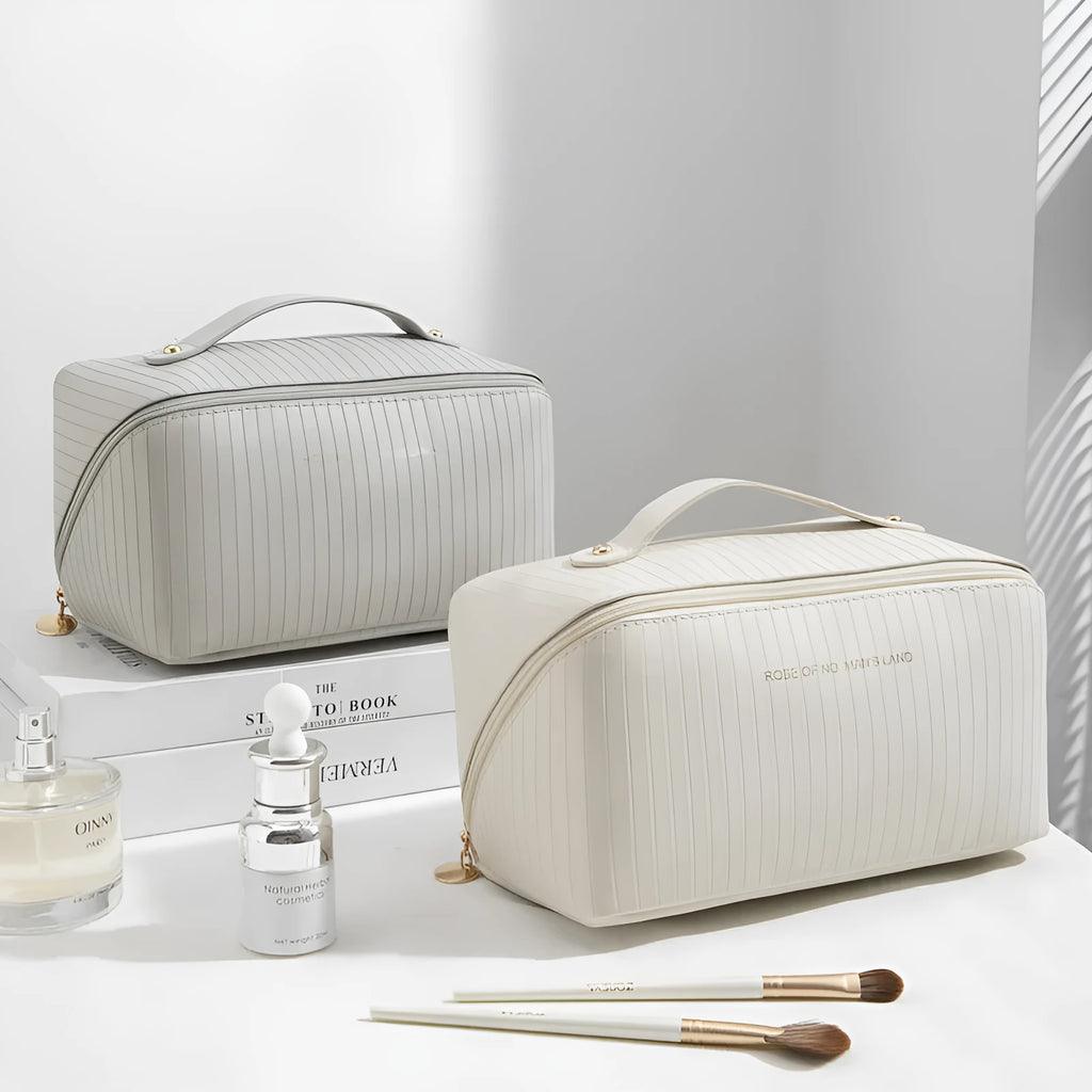 Cubic pillow-shaped PU makeup bag in a vertical pattern, shown in one of five colours: beige, black, brown, grey, or pink.