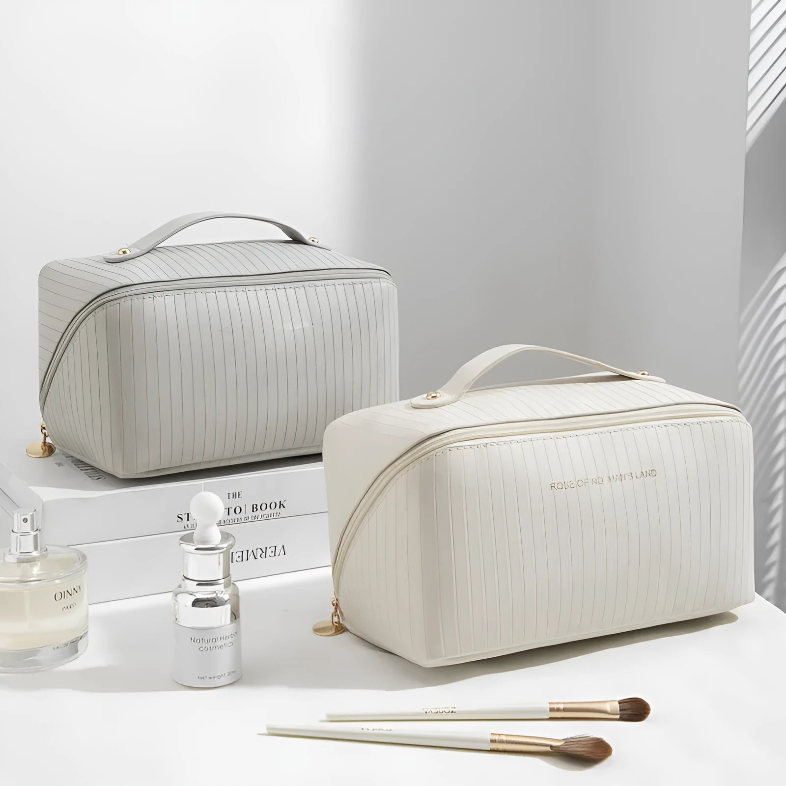 Cubic pillow-shaped PU makeup bag in a vertical pattern, shown in one of five colours: beige, black, brown, grey, or pink.