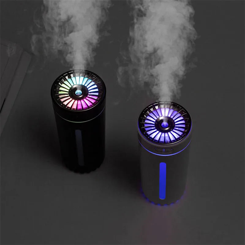 Black portable car humidifier with colourful LED lights on car cup holder showing mist output