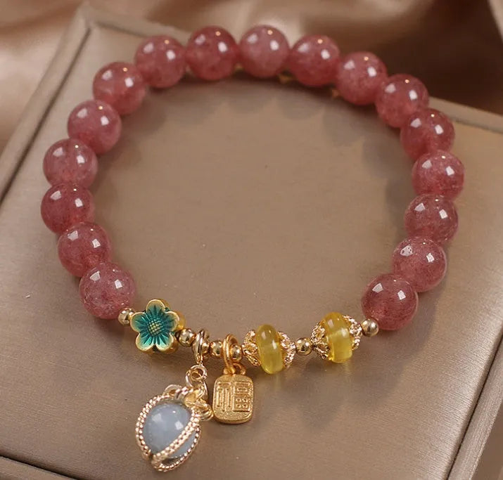 Red women's bracelet with natural strawberry quartz beads and rhinestone details on alloy setting