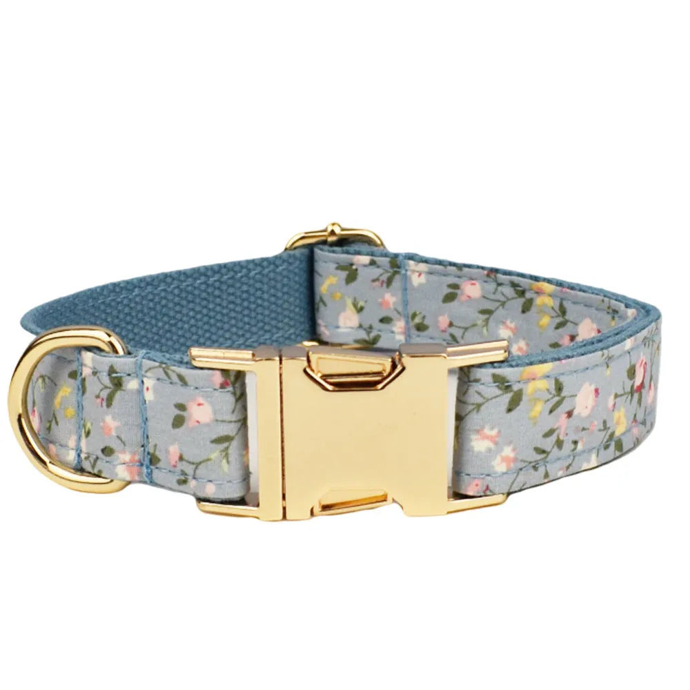 Blue floral patterned cloth dog collar set with matching leash, bow, and vest for small to extra-large dogs.
