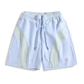 Men's black loose-fit quick-drying sports shorts with elastic waistband on a grey background