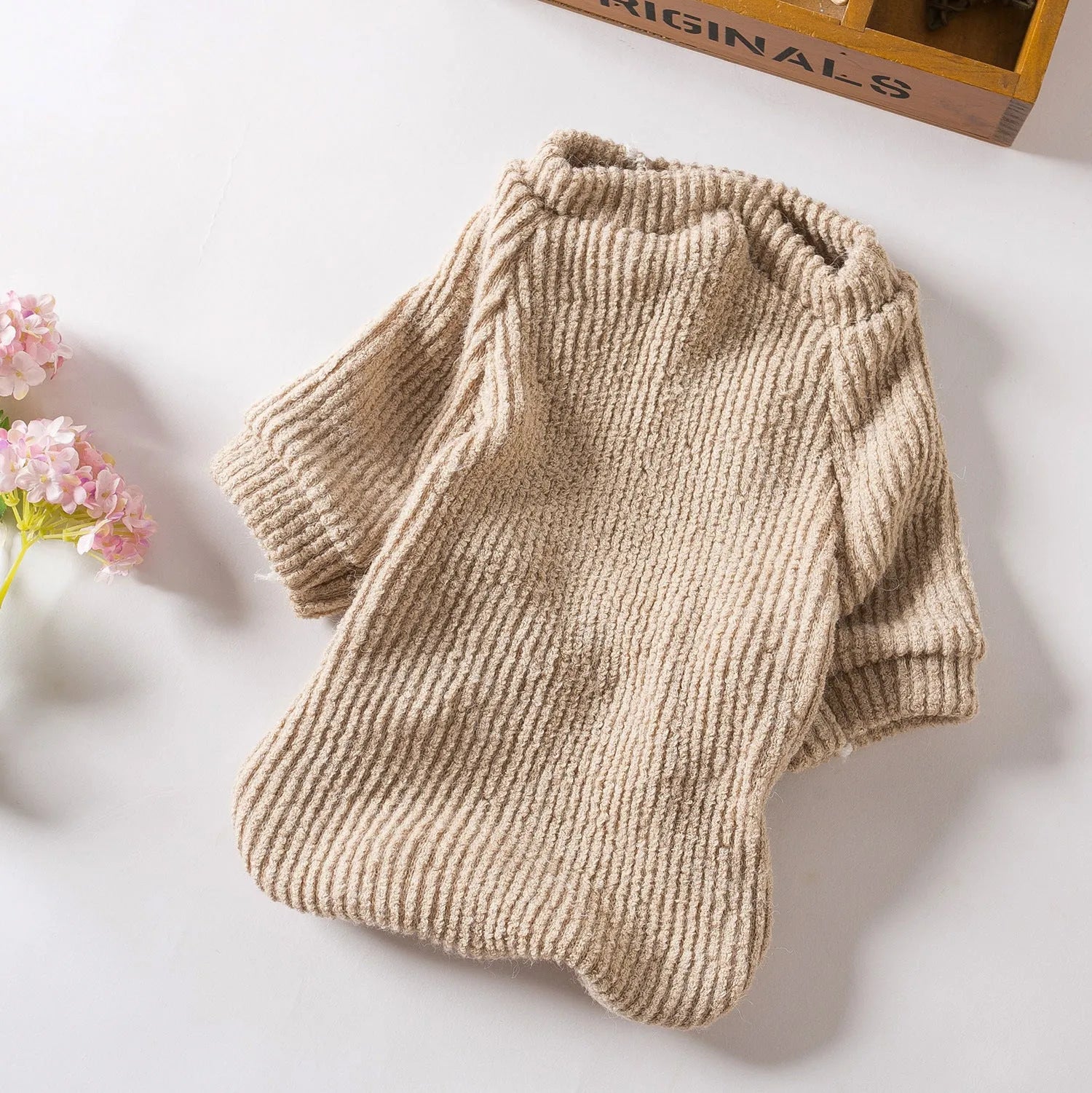 Brown knitted dog sweater pullover on small dog showing cloth construction and casual style