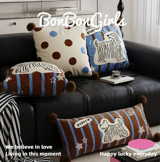 Blue cartoon animal print square sofa cushion on a grey sofa.