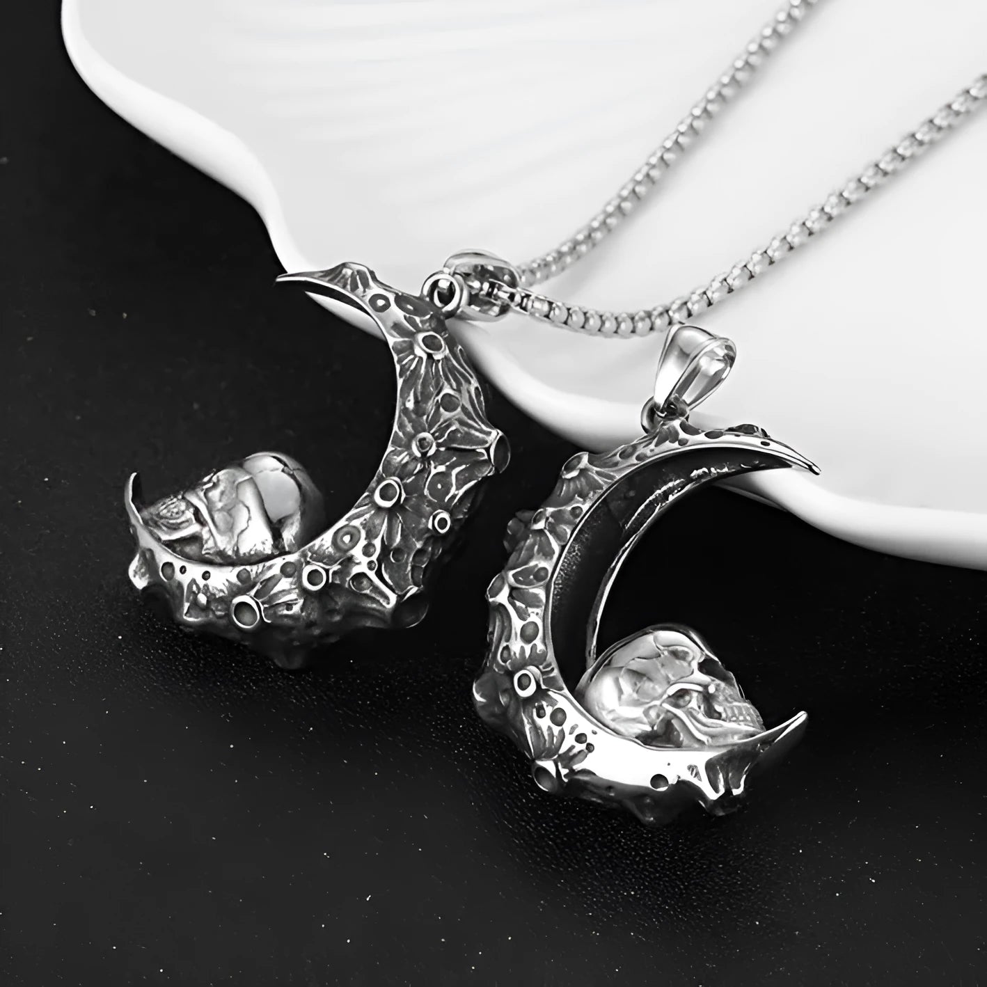 Men's stainless steel skull necklace with electroplated silver finish showing six pendant design variations