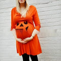 Orange cotton maternity dress for Halloween and seasonal wear on a mannequin