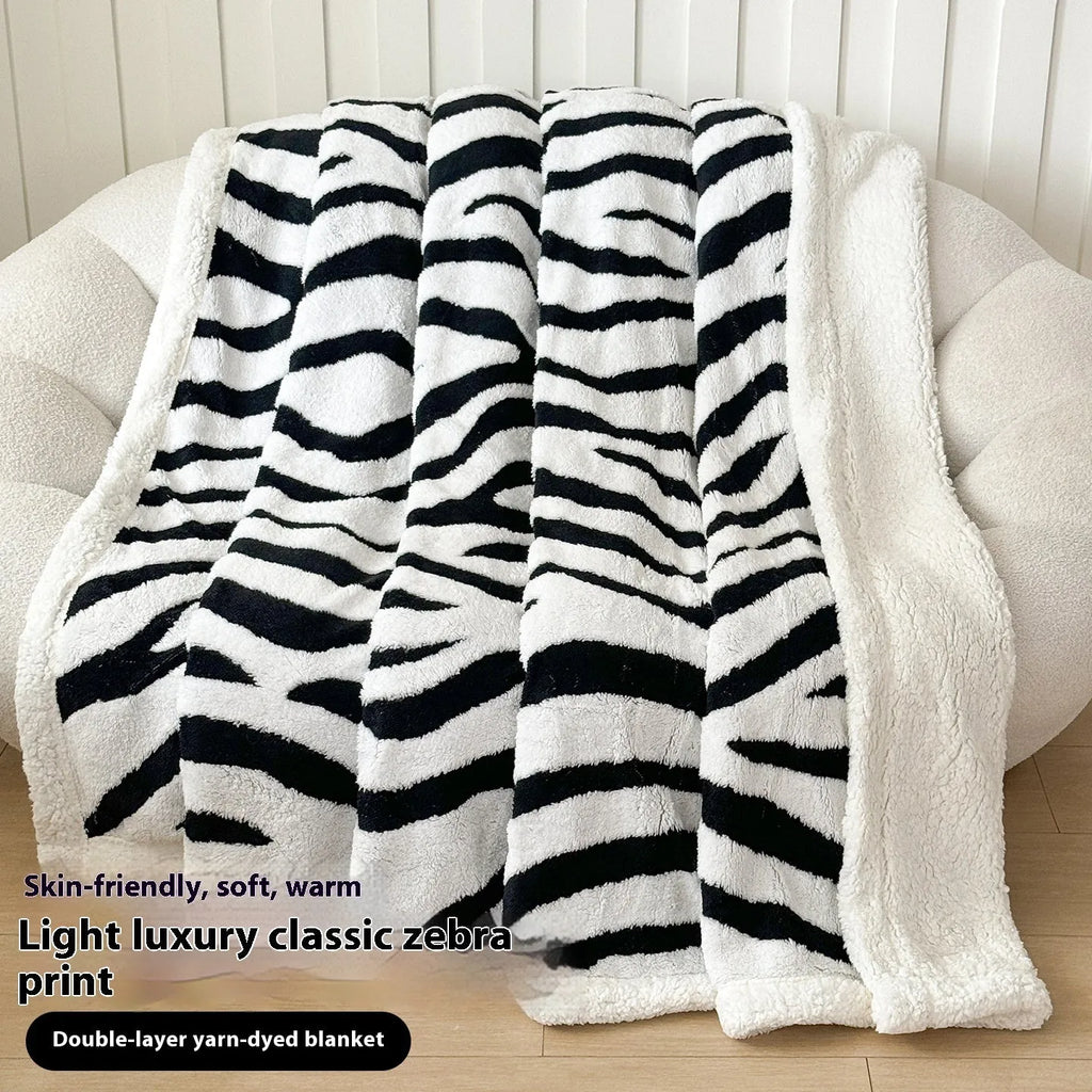 Double-layer jacquard taffeta blanket with leopard print pattern in camel colour on a bed.