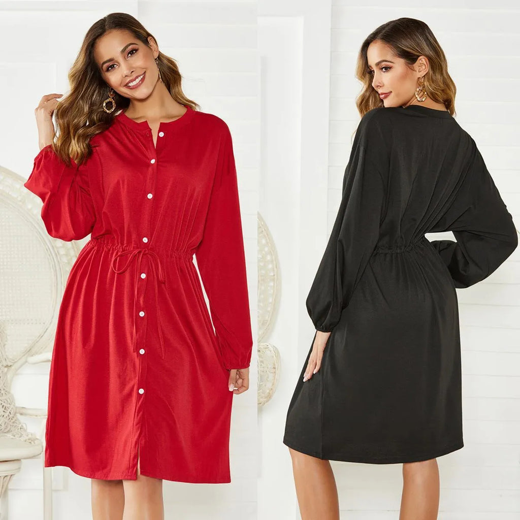 Black women's A-line midi dress with long sleeves, elastic waist, cuffs, and a matching belt.